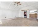 Spacious living room with vaulted ceilings, carpet and an open layout for entertaining at 540 Hickory St, Hudson, CO 80642