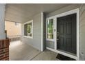 Close-up of a home's front porch, featuring a black front door and a large window at 18121 E Adriatic, Aurora, CO 80013