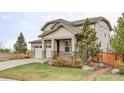 Attractive home featuring manicured lawn, mature trees, neutral siding, stone accents, and a two-car garage at 500 176Th Ave, Broomfield, CO 80023