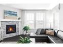 Living room showcasing dark wood flooring, corner fireplace, and large windows at 500 176Th Ave, Broomfield, CO 80023