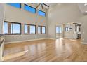 Open-concept living room with high ceilings and large windows at 16250 Kenosha St, Brighton, CO 80603