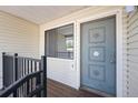 Close-up of the front door featuring a secure entry, screen and decorative moldings for enhanced curb appeal at 6007 Yarrow St # I, Arvada, CO 80004