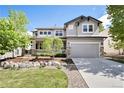 Charming two-story home boasts a welcoming front porch and attached two-car garage, set on a well-maintained lot at 8548 Winter Berry Dr, Castle Pines, CO 80108