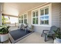 Relaxing front porch featuring outdoor seating, a patterned rug, and ample space for enjoying the outdoors at 8548 Winter Berry Dr, Castle Pines, CO 80108