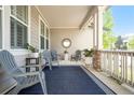 Inviting front porch featuring comfortable seating, a stylish rug, and decorative accents creating a cozy outdoor space at 8548 Winter Berry Dr, Castle Pines, CO 80108
