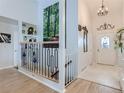 Bright foyer featuring wood floors, a decorative chandelier, and stylish decor at 13908 E Linvale Pl, Aurora, CO 80014