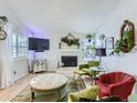 Cozy living room featuring a white fireplace, large TV, and comfortable seating at 13908 E Linvale Pl, Aurora, CO 80014