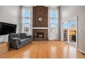 Living room with hardwood floors, fireplace, and lots of natural light at 14204 E Baltic Cir, Aurora, CO 80014