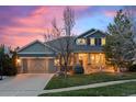 Charming two-story home with stone accents, a cozy front porch and professional landscaping at 24547 E Easter Pl, Aurora, CO 80016