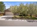 Charming two-story home featuring a brick facade, covered porch, and lush front lawn at 5934 Kingsfield St, Castle Rock, CO 80104