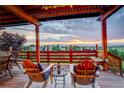 Relaxing outdoor patio with chairs and a table, perfect for enjoying the scenic views and sunset at 9537 Chesapeake St, Highlands Ranch, CO 80126
