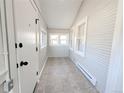 Cozy sunroom featuring neutral colors and tile flooring at 1164 Wabash St, Denver, CO 80220