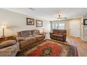 Cozy living room featuring hardwood floors, a ceiling fan, and comfortable seating area at 5786 Biscay St, Denver, CO 80249