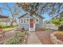 Charming single-story home with a red door, landscaped front yard, and inviting curb appeal at 3201 S Clarkson St, Englewood, CO 80113