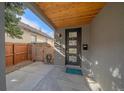 Welcoming front porch featuring a modern door with glass panels and wooden gate at 1437 Garfield St, Denver, CO 80206