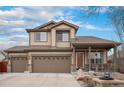 Charming two-story home with a three-car garage, covered front porch, and well-maintained landscaping offers curb appeal and functionality at 15776 E 107Th Way, Commerce City, CO 80022