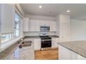 Modern kitchen with stainless steel appliances and granite countertops at 23881 E 40Th Ave, Aurora, CO 80019