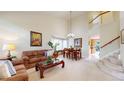 Inviting living room with high ceilings, neutral colors, and a staircase at 13307 Humboldt Dr, Thornton, CO 80241