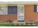 Close-up of the front door highlighting brick facade, stylish number, and decorative security gate at 3400 Garland St, Wheat Ridge, CO 80033