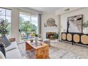 Inviting living room with a cozy fireplace, elegant furnishings, and a balcony overlooking lush greenery at 1862 Mallard Dr, Superior, CO 80027