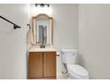 Bathroom with a vanity, wooden framed mirror, and toilet at 3061 W 92Nd Ave # 14A, Westminster, CO 80031