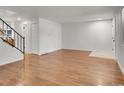 Bright living room with gleaming hardwood floors, white walls, and a staircase at 3061 W 92Nd Ave # 14A, Westminster, CO 80031