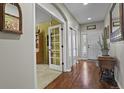 Welcoming home entryway featuring hardwood floors with an office through glass paneled doors at 10153 Pagosa St, Commerce City, CO 80022