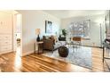 Bright living room with hardwood floors, neutral colors, large windows, and stylish furniture at 3045 Kearny Street, Denver, CO 80207