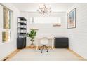 Bright home office with modern desk, ample storage, and elegant chandelier at 3957 Utica St, Denver, CO 80212