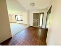 Foyer with tile flooring, decorative front door and views of the living room at 53 Douglas S Dr, Broomfield, CO 80020