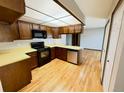 Kitchen features wooden cabinets, black appliances and light countertops at 53 Douglas S Dr, Broomfield, CO 80020