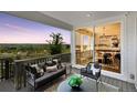 Relaxing covered balcony showcasing comfortable seating and scenic views of nature at 13326 Blue Amber Ct, Parker, CO 80134