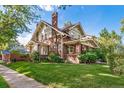 Side view of a charming brick home with a spacious lawn at 2203 Bellaire St, Denver, CO 80207