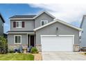 Charming two-story home featuring gray siding, a two-car garage, and a well-maintained front yard at 9406 Bross St, Arvada, CO 80007
