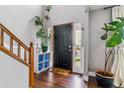 Inviting foyer featuring hardwood floors, a black front door, and stylish decor, creating a warm welcome at 5370 S Flanders Way, Centennial, CO 80015