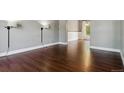 Bright living room features hardwood floors and modern sconce lighting, creating a sleek and inviting space at 5370 S Flanders Way, Centennial, CO 80015