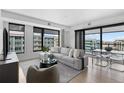 A bright open-concept living space features modern furnishings and plenty of natural light at 1750 Wewatta St # 1301, Denver, CO 80202