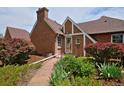 A brick home featuring a stone walkway and lush landscaping at 2500 Locust St, Denver, CO 80207