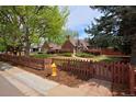 Charming brick home with a fenced yard and manicured lawn at 2500 Locust St, Denver, CO 80207