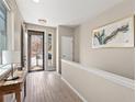 Light and airy entryway with hardwood floors and a view to the backyard at 3280 Youngheart Way, Castle Rock, CO 80109