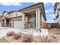 Two-story house with stone accents, front porch, and attached garage at 3280 Young Heart Way, Castle Rock, CO 80109