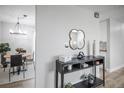 Stylish entryway with modern decor, decorative mirror, console table, and view of dining area at 441 Elbert Way, Denver, CO 80221