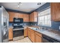 Functional kitchen featuring stainless steel appliances, wooden cabinetry, and lots of natural light at 1473 Red Cliff Way, Castle Rock, CO 80109