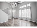 Bright living room with vaulted ceilings, large windows, and modern gray flooring at 1473 Red Cliff Way, Castle Rock, CO 80109