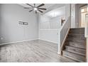 Spacious living room with modern gray floors and access to an open staircase at 1473 Red Cliff Way, Castle Rock, CO 80109