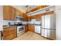 The kitchen has stainless steel appliances, wood cabinets and bright countertops at 12368 W Nevada Pl # 303, Lakewood, CO 80228