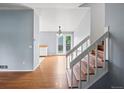 Bright entryway featuring wood floors, staircase, and an open layout connecting to other living spaces in the home at 298 S Hoover Ave, Louisville, CO 80027