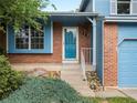 Inviting front porch with brick accents, steps leading to the blue front door, and the house number displayed at 298 S Hoover Ave, Louisville, CO 80027