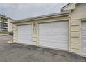 Attached two car garage features painted doors and close proximity to the building at 12338 W Dorado Pl # 107, Littleton, CO 80127