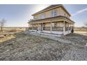 Stunning two-story home with a spacious yard and inviting porch, perfect for outdoor entertaining and Gathering gatherings at 14855 Almstead St, Hudson, CO 80642